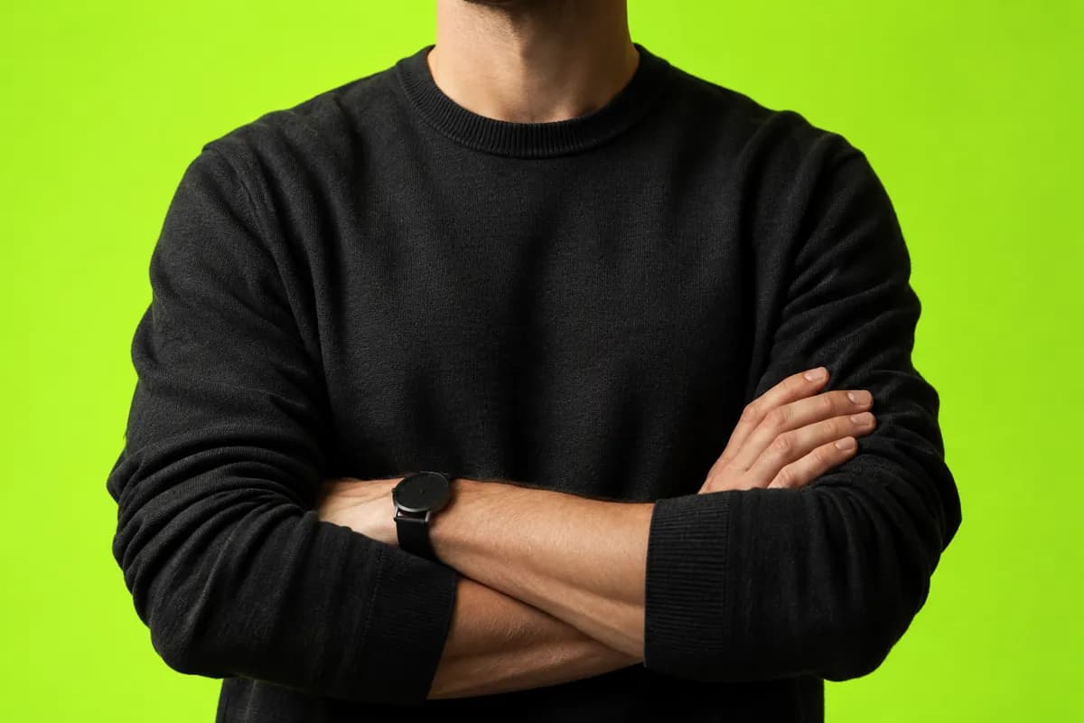 Cropped editorial portrait of Vidione co-founder Jonas Reed, shown from the shoulders down against a vivid lime background