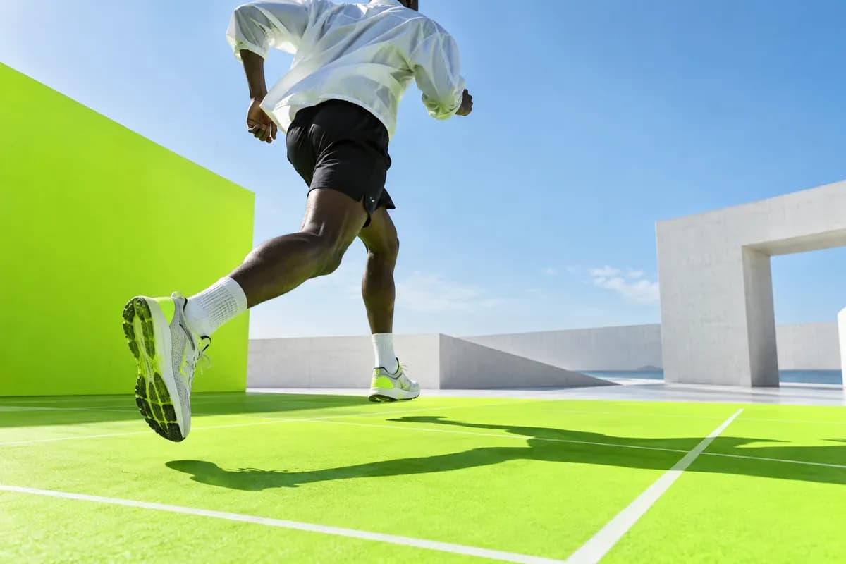 Silhouetted movement against a bright lime studio grid and pale blue sky