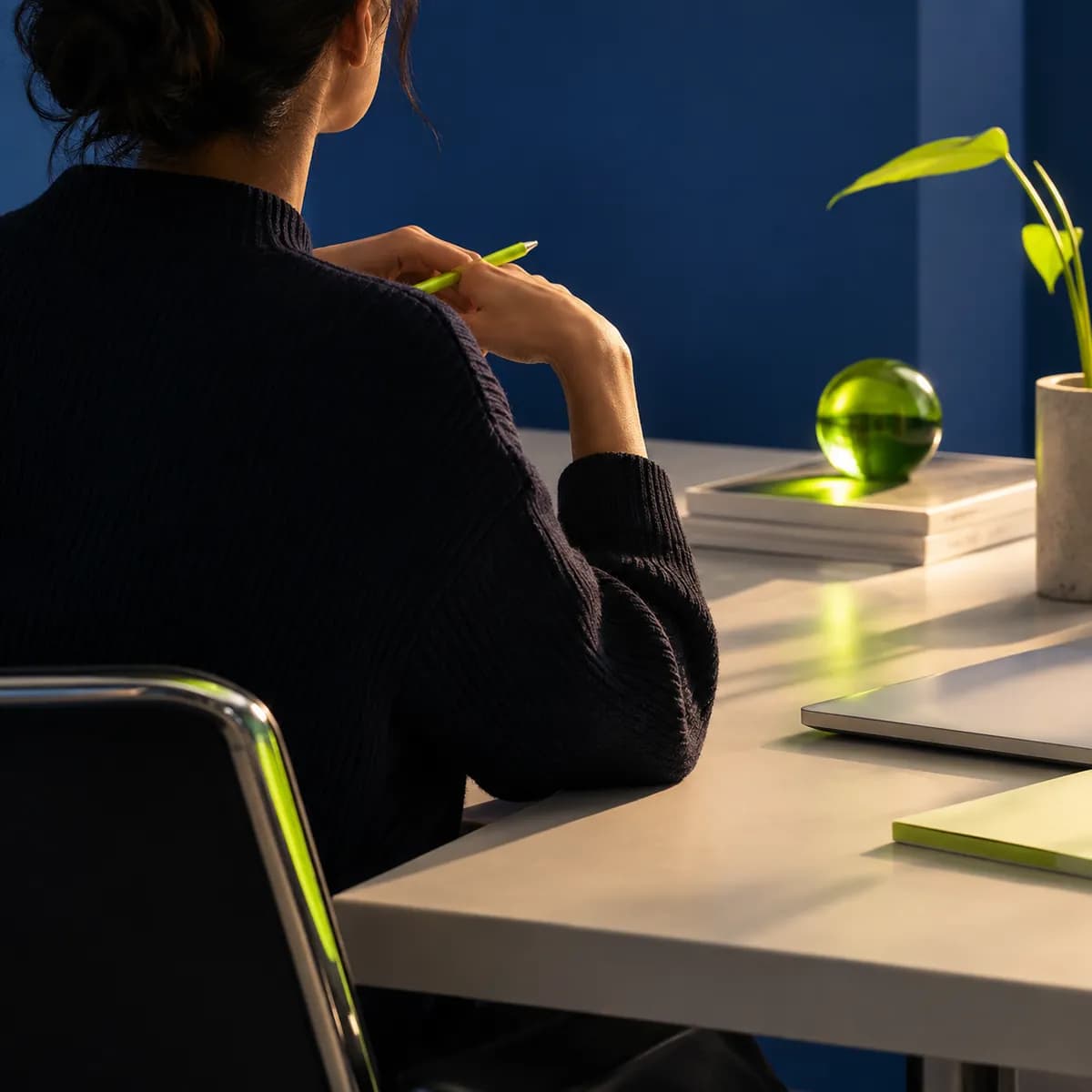 Backlit silhouette of a creative strategist in a cobalt studio