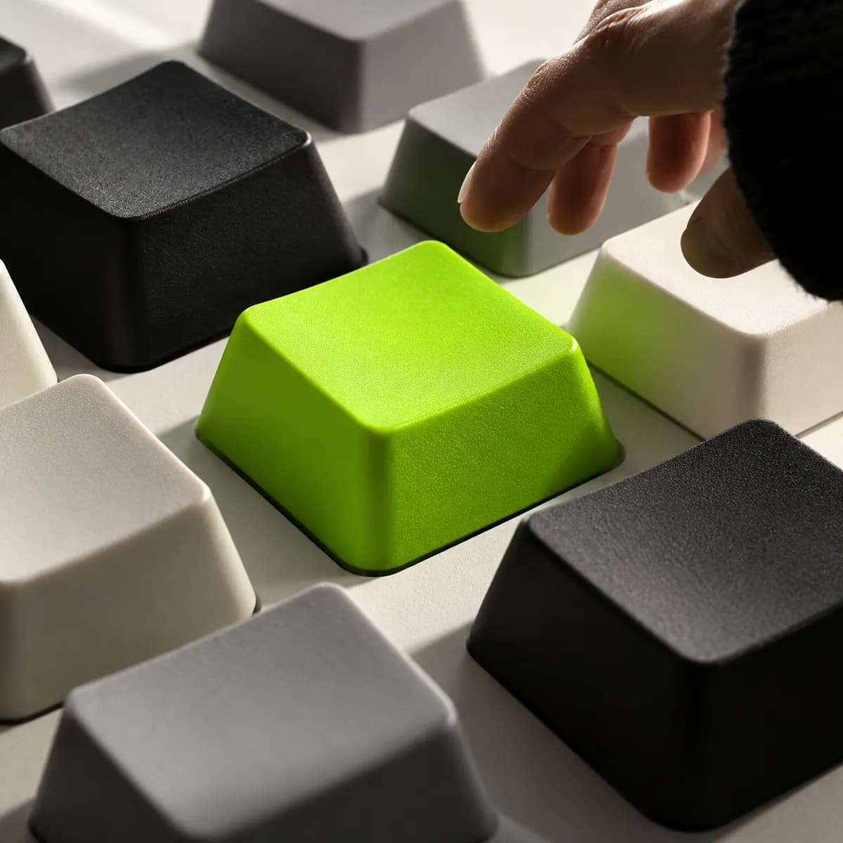 Three-dimensional neutral keys with one bright green key in the center