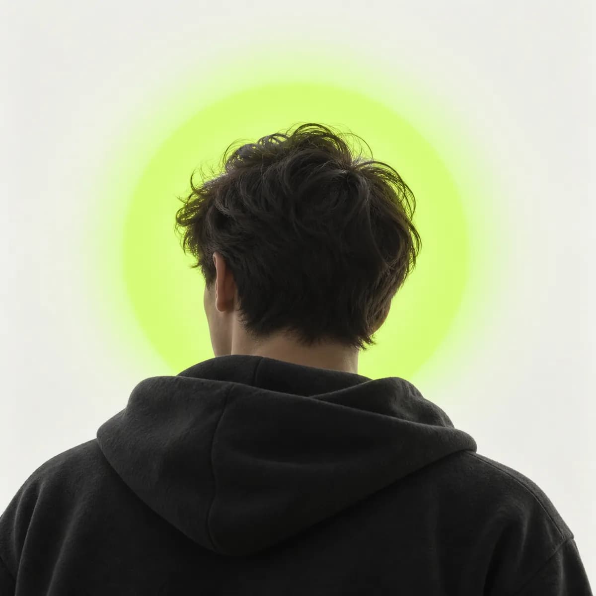 Anonymous cropped portrait silhouette against a pale lime gradient