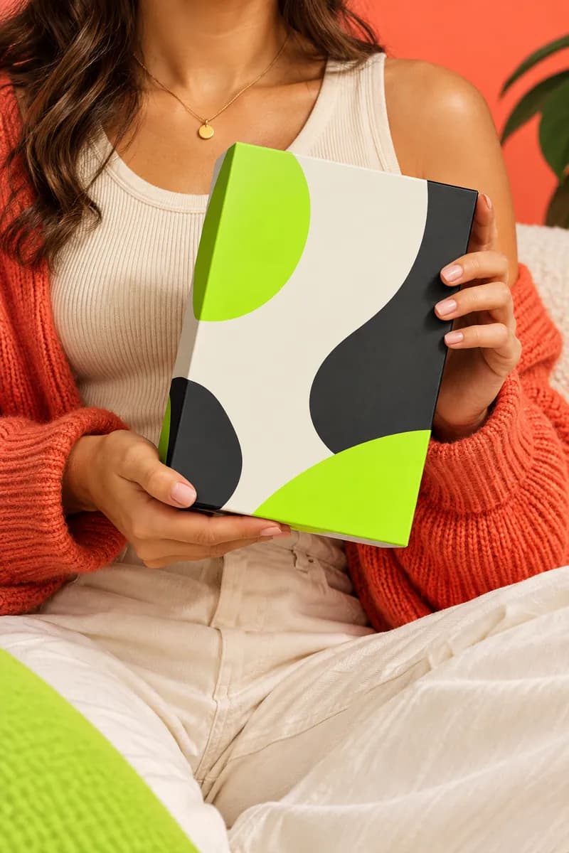 Person holding a colorful product package during a playful promotion