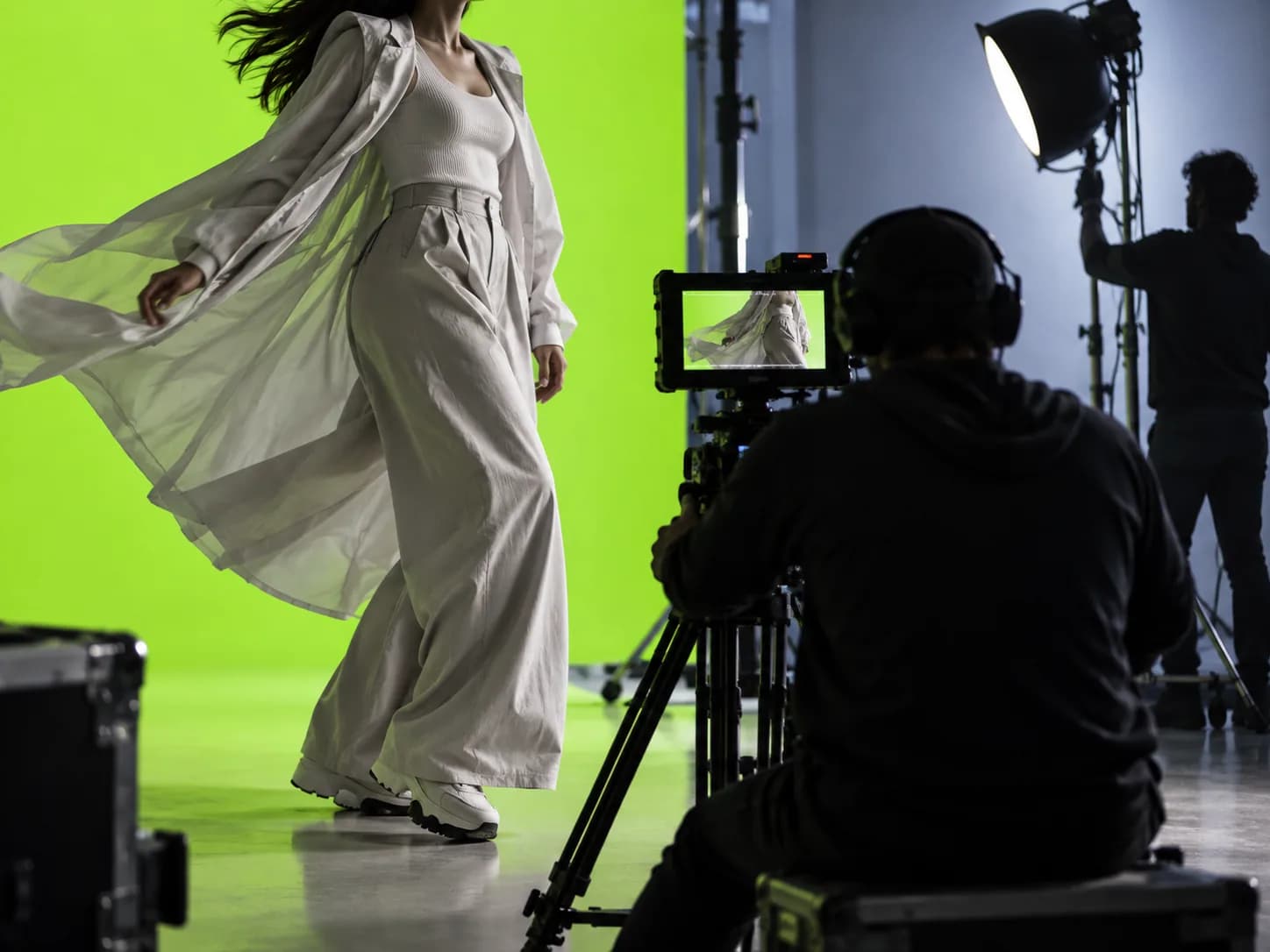 Abstract green-screen production scene with a bright lime backdrop and cropped creative subjects