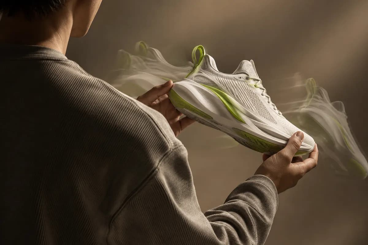 Abstract studio presentation of a sneaker with a soft lime download accent and layered motion trails