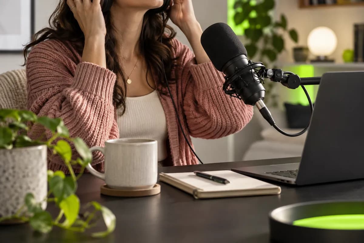 Home podcast recording setup with headphones and a professional microphone