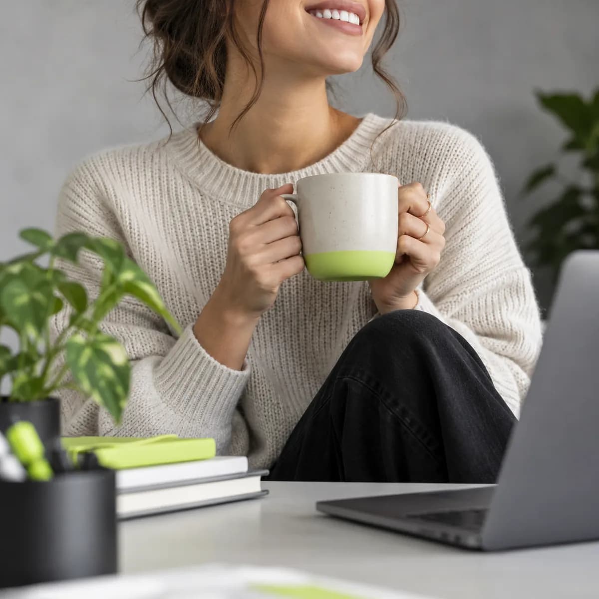 Cropped silhouette of a smiling creator in a neutral studio