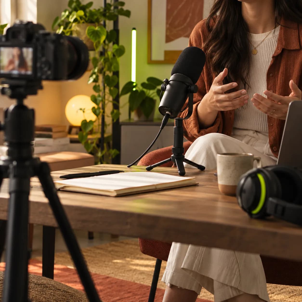 Abstract video creation scene with a warm studio, camera equipment, and a lime accent light