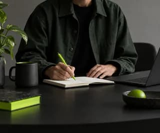 Anonymous educator cropped below the chin in a softly lit recording room