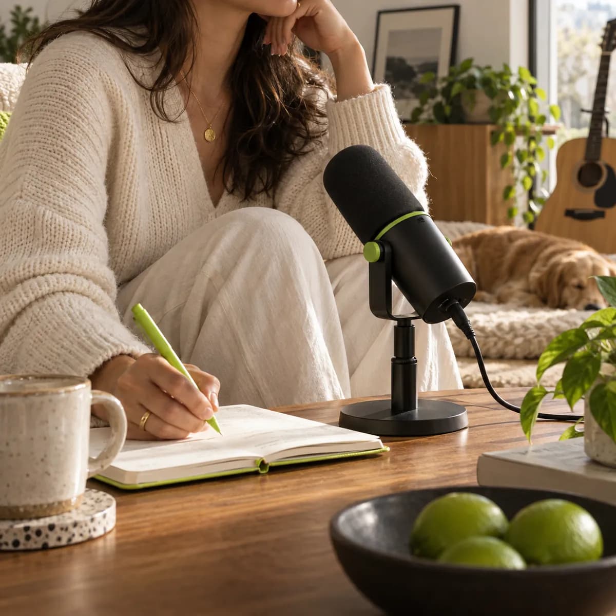 Anonymous creator cropped below the chin working beside a black studio microphone