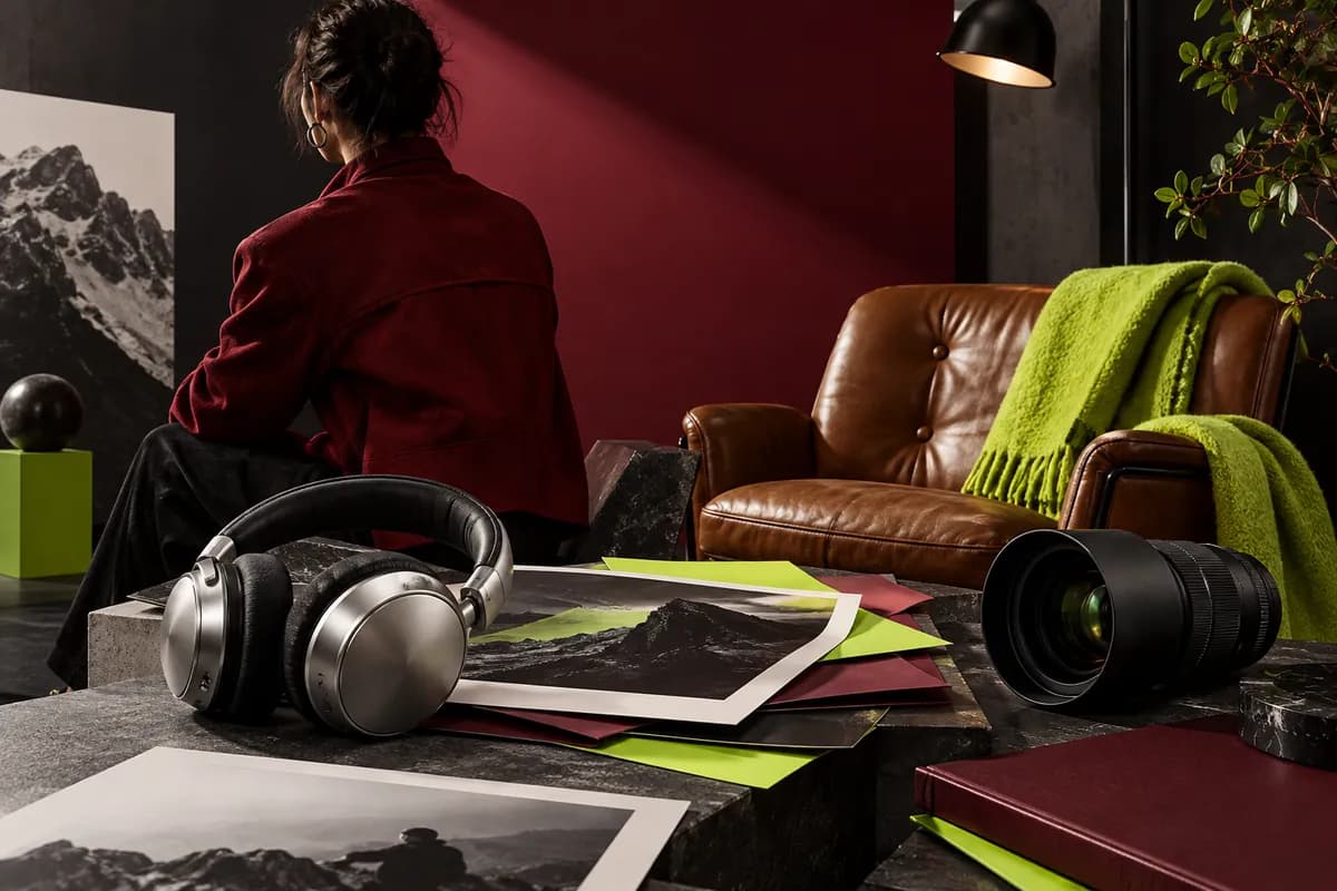 Editorial red jacket and creative tools arranged in a polished studio scene