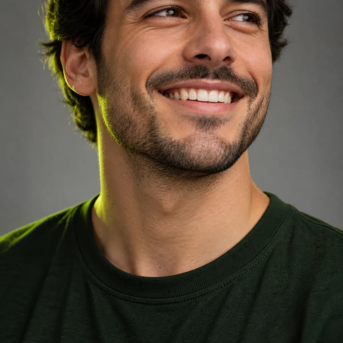 Creator cropped below the chin in a dark green shirt
