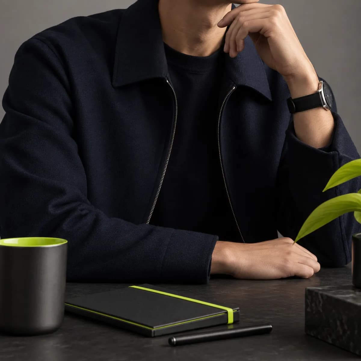 Creator cropped below the chin in a navy jacket