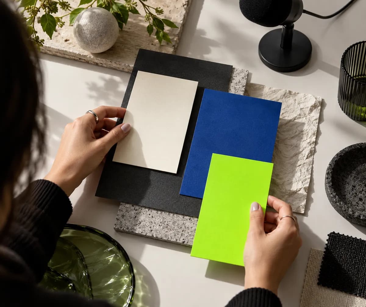 Abstract close-up of hands arranging subtitle-inspired color cards on a desk