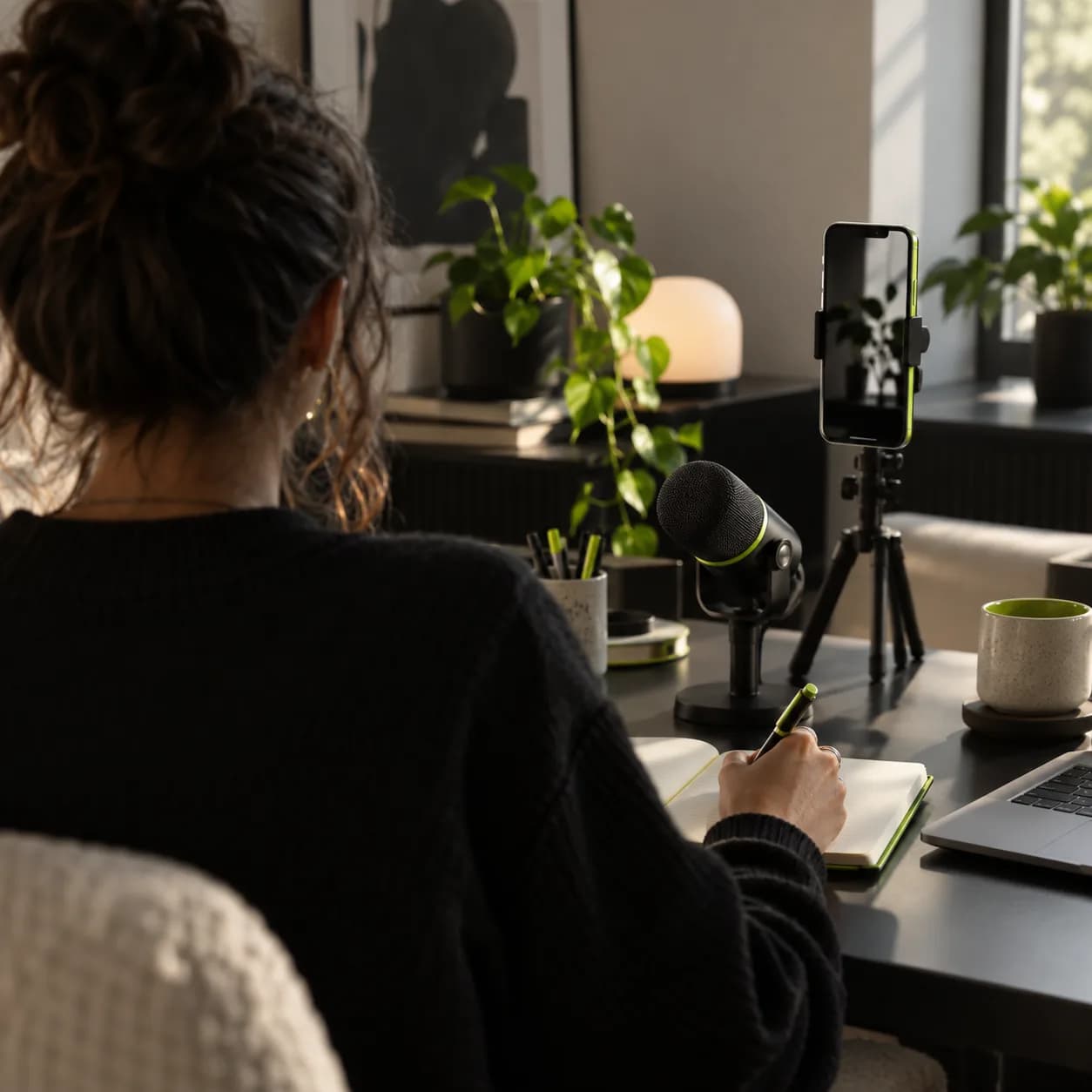 Creator working at a desk with a microphone and editing setup